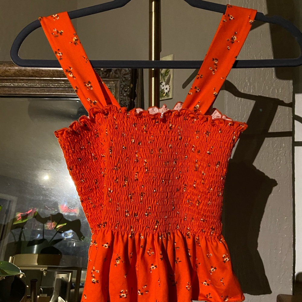 Smocked peplum orange floral tank top